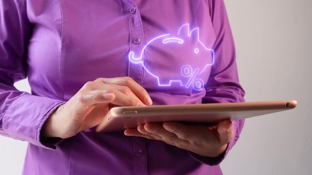 Financial return on savings. Close-up of a businesswoman interacting with her tablet, showing a virtual piggy bank icon with a percentage sign.