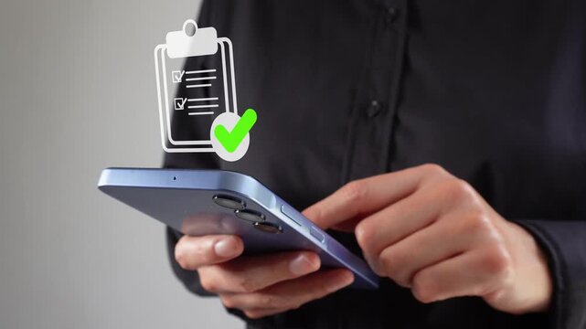Hands hold smartphone, tap screen. Digital clipboard icon floats above. Green checkmark appears. Person wears dark shirt, focused on device. Ideal for business, digital task completion