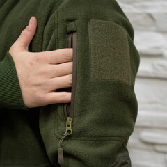 Person Wearing Green Fleece Jacket with Sleeve Pocket © Алексей Божко