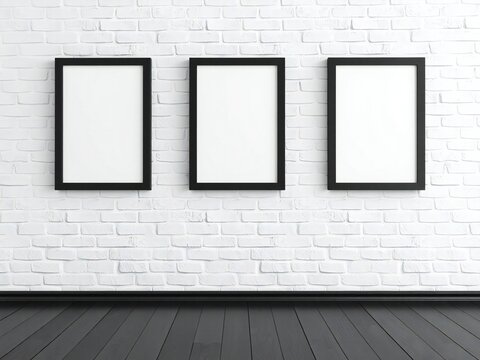 Three empty frames on white brick wall