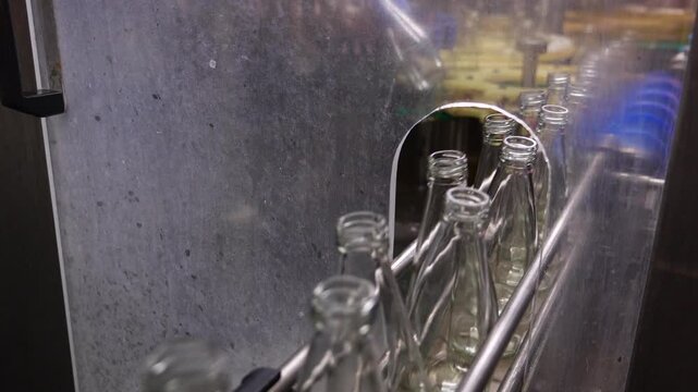 Commercial production line automation showcasing efficient beverage packaging workflow industrial equipment manufacturing empty bottles quality control standards supply chain logistics.