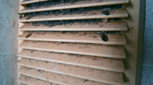Dirty Ventilation Grille Covered with Dust and Cobwebs Close Up | Wide-Angle Vertical Pan Along Dirty Air Vent Slats | HVAC Maintenance Concept