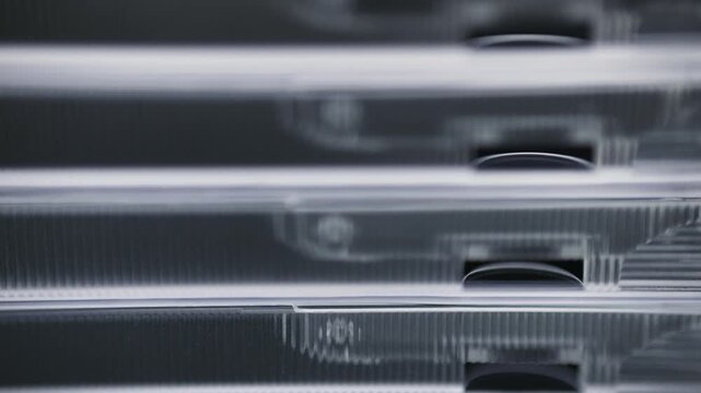 Stacked transparent plastic cd jewel cases close up view.