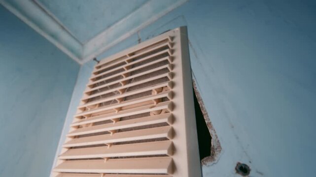 Ventilation Grille Being Removed from Wall Close Up | Wide-Angle Vertical Pan Along Loose Air Vent Cover with Wall Damage | HVAC Repair Concept