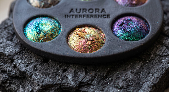 Interference multi-chrome eyeshadow palette close up showing iridescent pigment pans
