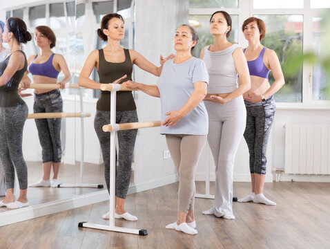 Choreographer coach teaches amateur students to keep their heads straight during a ballet lesson