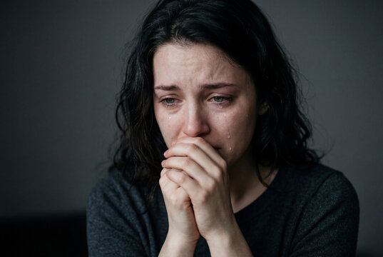 Close up portrait of a sad young woman crying with tears on her face