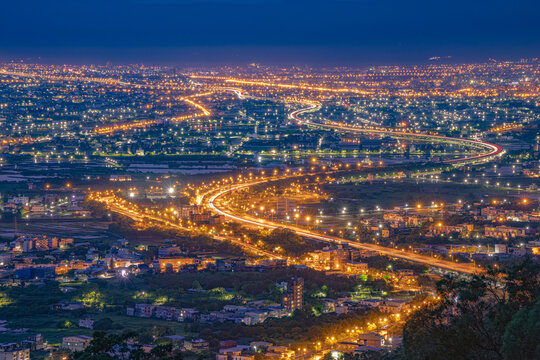 Yilan Plain highway light trails and city lights at blue hour