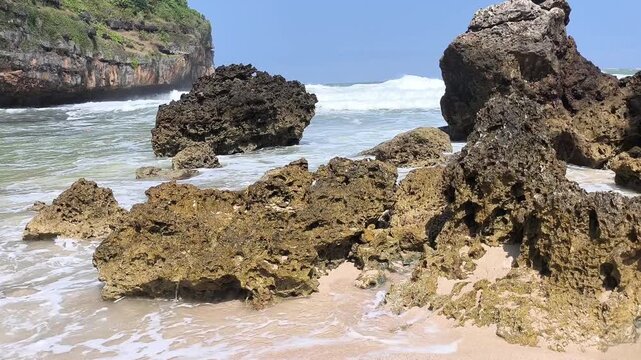 Rugged rocks stand firm against crashing ocean waves