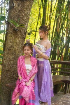 Traveler and woman tourist enjoy walking to see the historic park of Thailand exciting to explore the wonderful place of sightseeing.