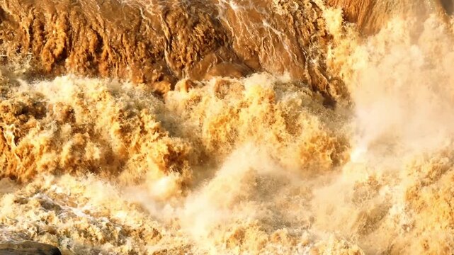Drone aerial view of fast-flowing floodwater with sediment waves, showcasing natural disasters, watershed dynamics, climate resilience, and the urgent need for flood prevention solutions. 4k.
