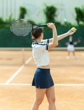 Several girls play tennis two on two. Friendly tournament, sports Universiade, opening of tennis season.