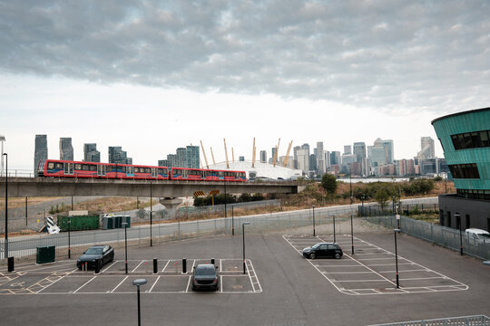 London dlr train crossing bridge with canary wharf skyline