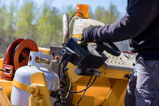 Worker operates machinery in construction site d move materials on job