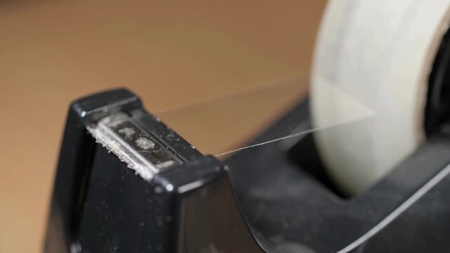 close up sticky tape torn from a table top dispenser.