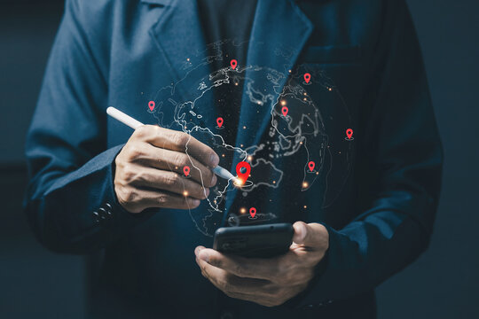 Business professional uses smartphone and stylus with a digital world map and location pins, illustrating global navigation, logistics, tracking, connectivity, and location technology.