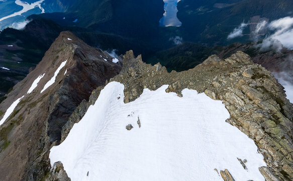 Aerial Snowy Mountain Ridge and Rocky Peak Over Valley Lakes Near Chilliwack, British Columbia
