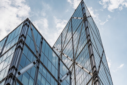 View of the modern glass facade and steel structural beams of a skyscraper in Shoreditch, London, England, United Kingdom.