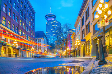 Famous steam clock emitting plume of steam on historic brick street during twilight in Gastown, Vancouver © f11photo