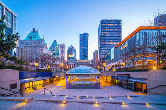 Public plaza at dusk with downtown Vancouver skyline , British Columbia