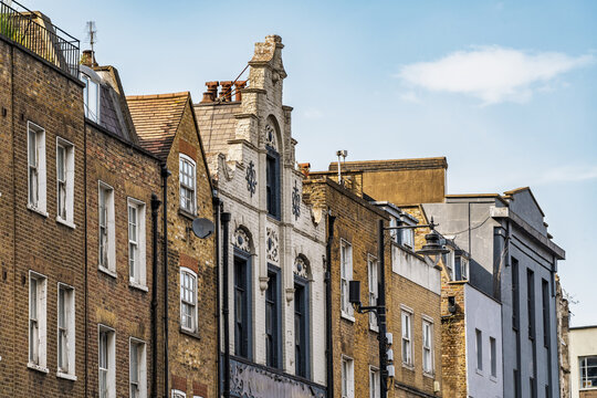 View of historic brick buildings with ornate architectural details in Shoreditch, London, England, United Kingdom.