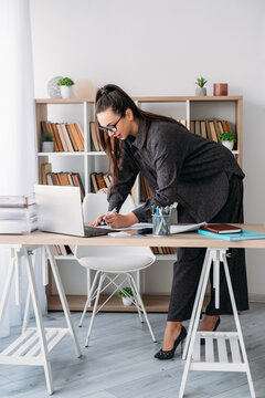 Business routine. Office lifestyle. Female professional manager preparing for job at desk with notebook laptop at modern workplace.