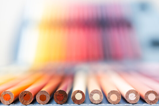 colorful pencils lined up in pencil case with shallow depth of field