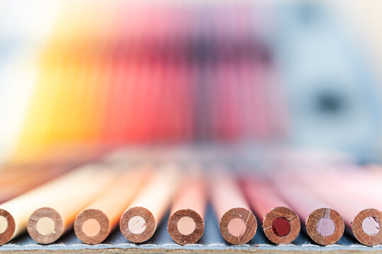 colorful pencils lined up in pencil case with shallow depth of field