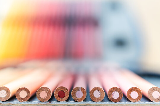 colorful pencils lined up in pencil case with shallow depth of field