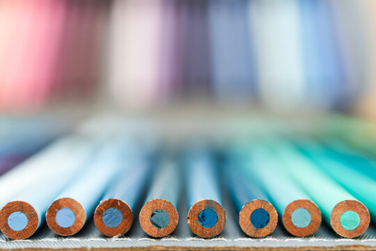 colorful pencils lined up in pencil case with shallow depth of field