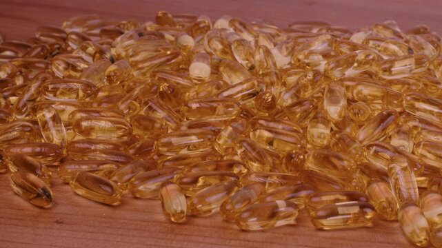 Cod Liver Oil Capsules Close Up. Supplement, Motion Left to Right