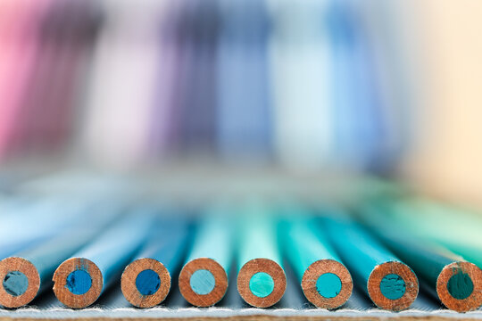 colorful pencils lined up in pencil case with shallow depth of field