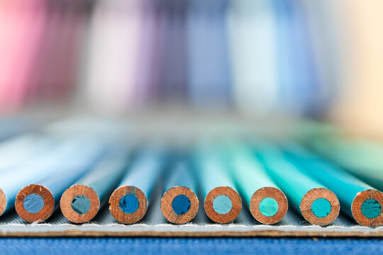 colorful pencils lined up in pencil case with shallow depth of field