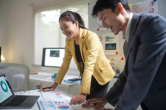 Business Team Reviewing Financial Charts in Office