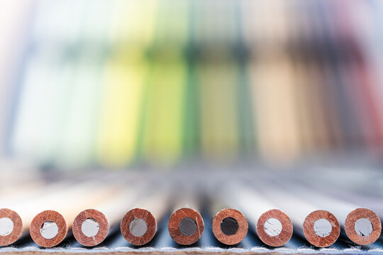 colorful pencils lined up in pencil case with shallow depth of field