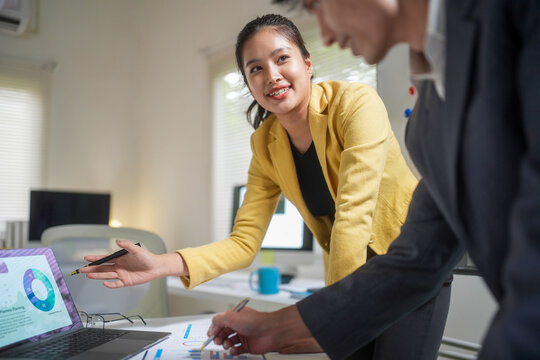 Business Team Discussing Financial Charts in Office