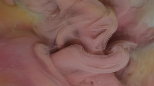 Ink water drop. Paint fog. Blur pink orange yellow color glitter cloud pigment splash acrylic mist spreading on abstract background.