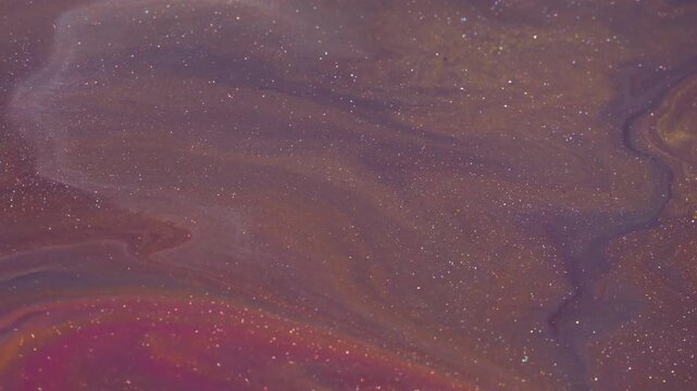 Shimmer ink flow. Acrylic glitter paint. Defocused orange purple yellow liquid texture particles floating on abstract art background.