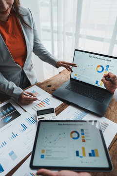 Business people analyzing sales performance data charts