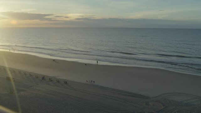 Early morning along the beach in Surfside, South Carolina with panning video.