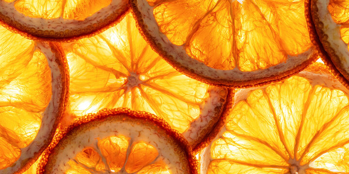 Closeup of flesh orange slices with juicy segments, seeds, glowing yellow vibrant texture. Health, vitamin C, nutrition, fresh juice concepts. Abstract food photo background. Minimal top view pattern.