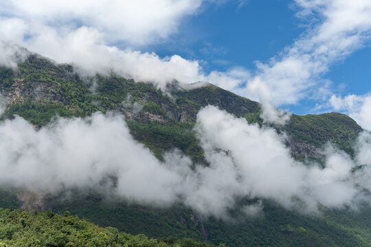 Majestic green mountains covered by flowing white clouds in Y Ty, Lao Cai province, Vietnam