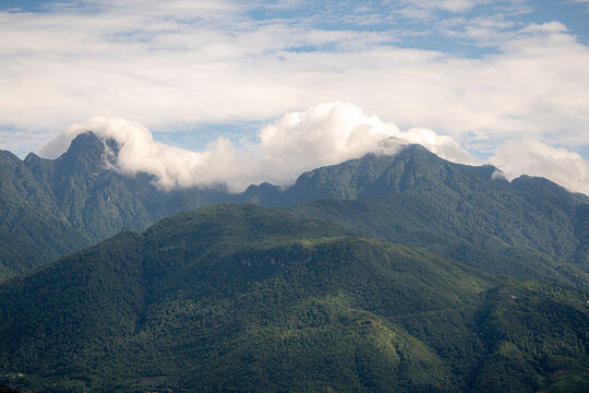 Majestic green mountains covered by flowing white clouds in Y Ty, Lao Cai province, Vietnam