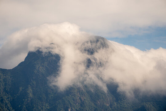 Majestic green mountains covered by flowing white clouds in Y Ty, Lao Cai province, Vietnam