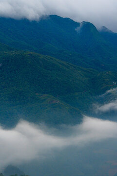 Majestic green mountains covered by flowing white clouds in Y Ty, Lao Cai province, Vietnam