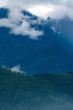 Majestic green mountains covered by flowing white clouds in Y Ty, Lao Cai province, Vietnam