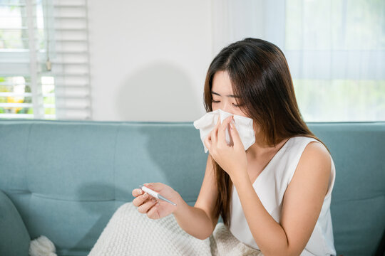 Sick woman have symptom sick high fever she checking her temperature with thermometer