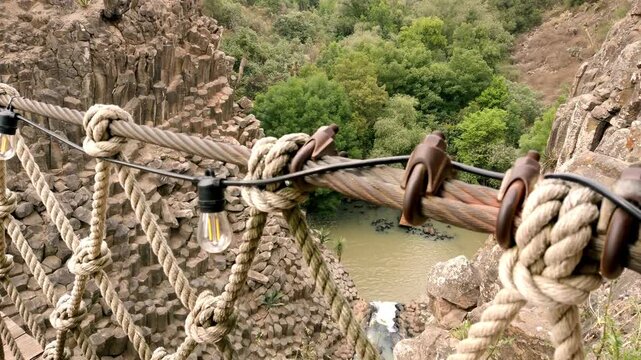 High angle view overlooking the Prismas Basalticos with striking basalt columns, waterfall, natural pool and surrounding forest in Hidalgo, Mexico