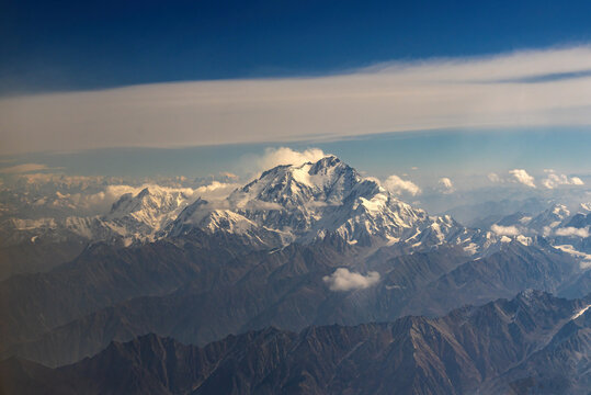 Aerial view of Nanga Parbat, the ninth highest mountain in the world, rising above the rugged, snow-capped peaks of the Himalayas, Gilgit-Baltistan, Pakistan.