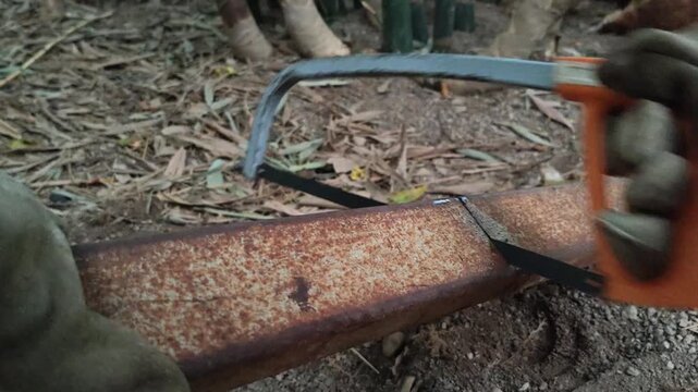 cutting iron with a manual hacksaw